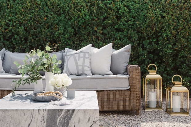 Sarah Walker backyard seating area with grey upholstery and gold lanterns
