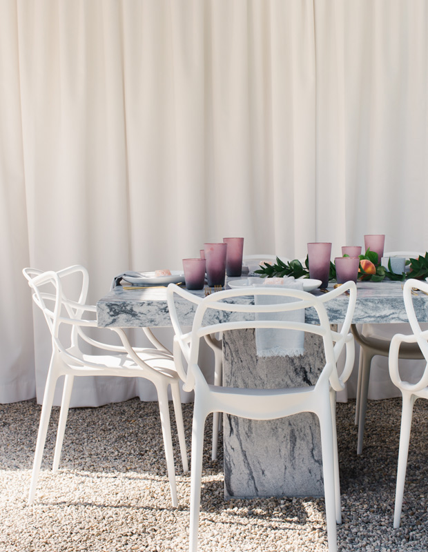 Sarah Walker backyard with sculptural chairs and marble table