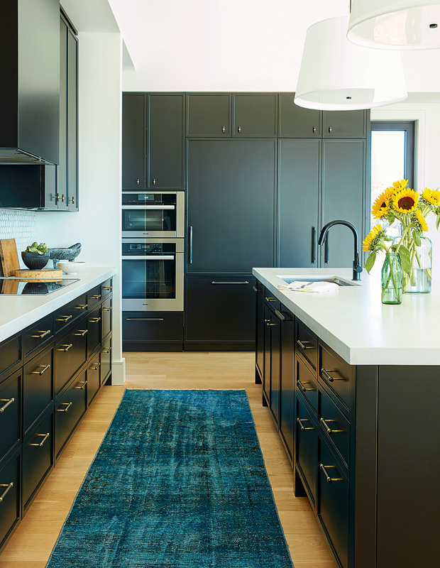Cameron MacNeil country home kitchen with brass pulls and black cabinetry