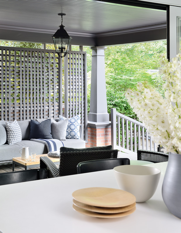 Indoor-outdoor kitchen with a charming seating area on the porch