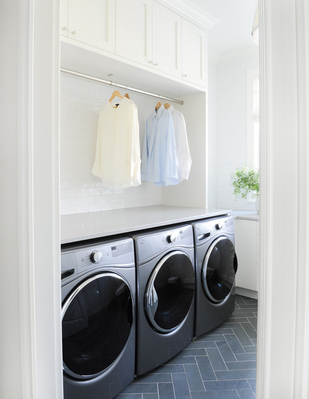 Luxe laundry room with built-in storage and hanging room