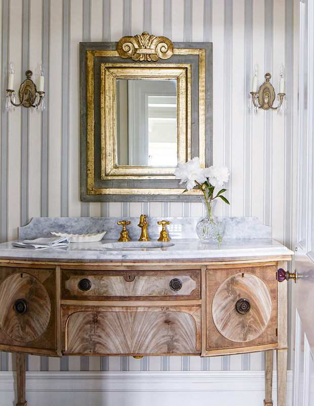 Tommy Smythe colonial revival powder room with striped wallpaper and gilded mirror