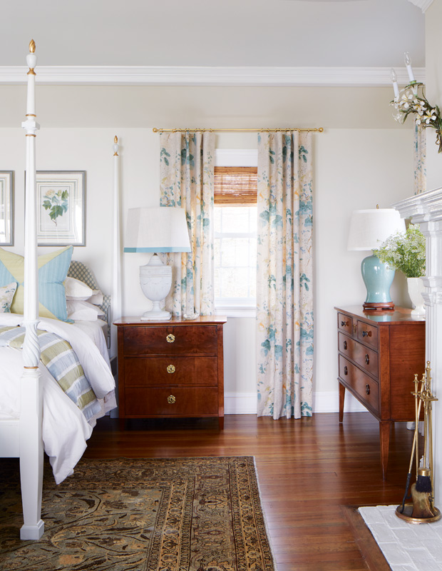 Tommy Smythe colonial revival principal bedroom with vintage furniture and floral drapes