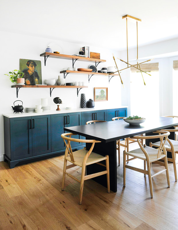 Eclectic kitchen with blue-green cabinets and oil portraits