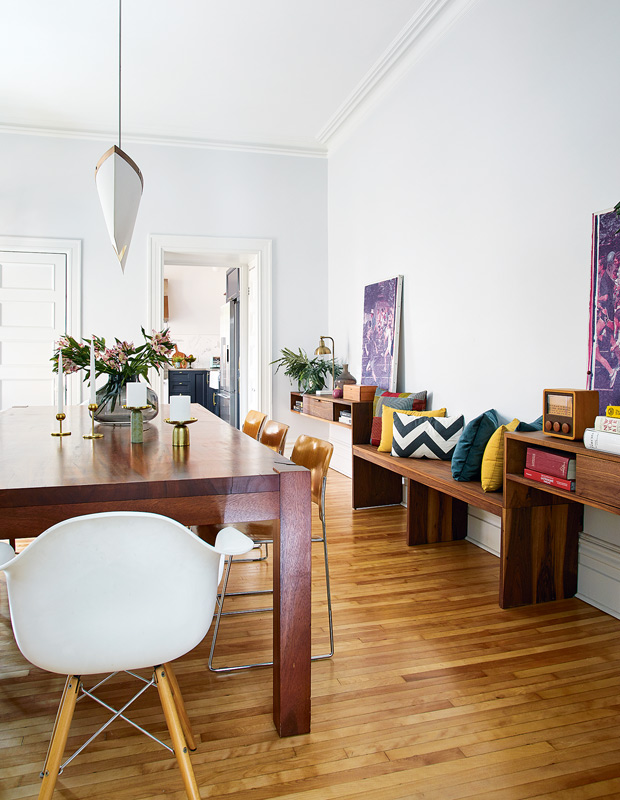Colourful Montreal Home dining room with built-in benches and eclectic chairs