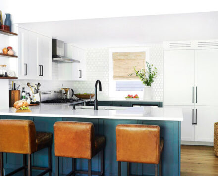 Eclectic kitchen with blue-green cabinets and oil portraits