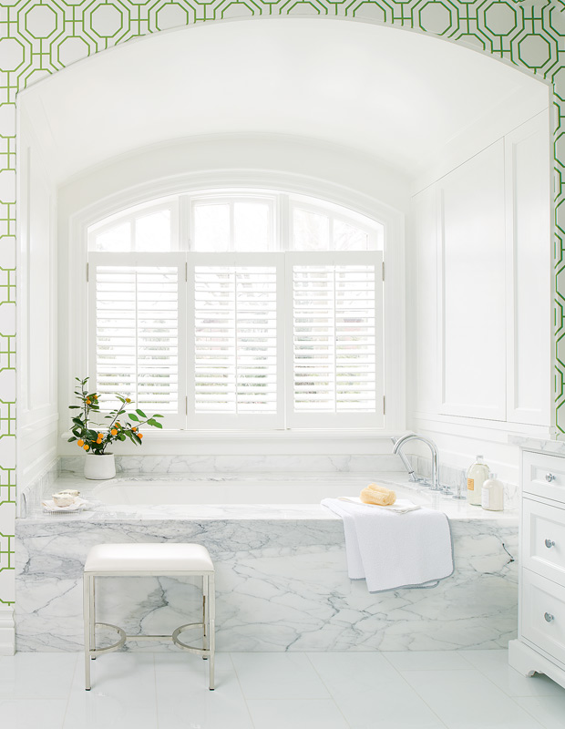 fresh and preppy bathroom arched windows and marble tub