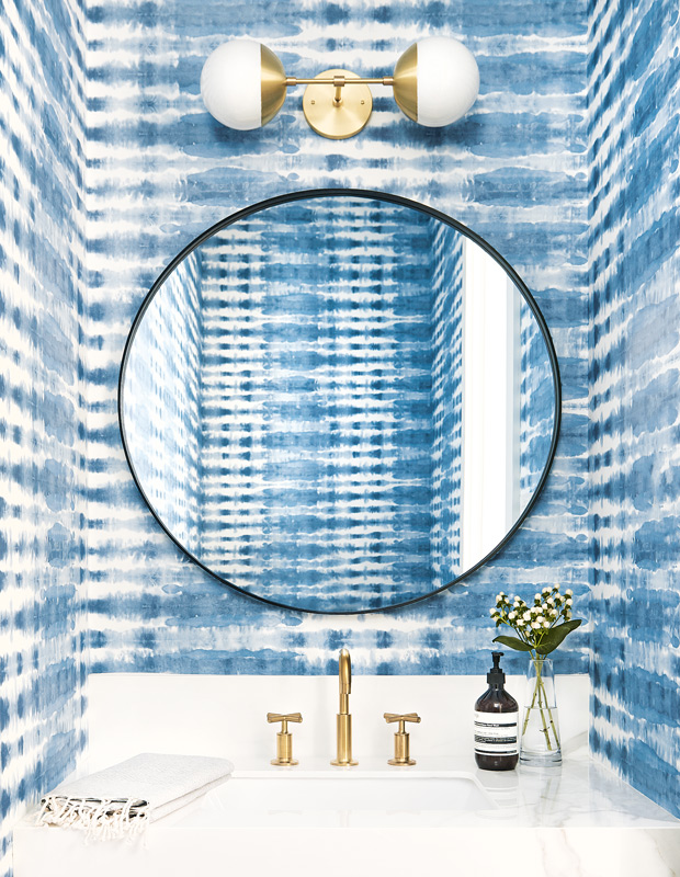 Powder room with blue tie-dye wallpaper