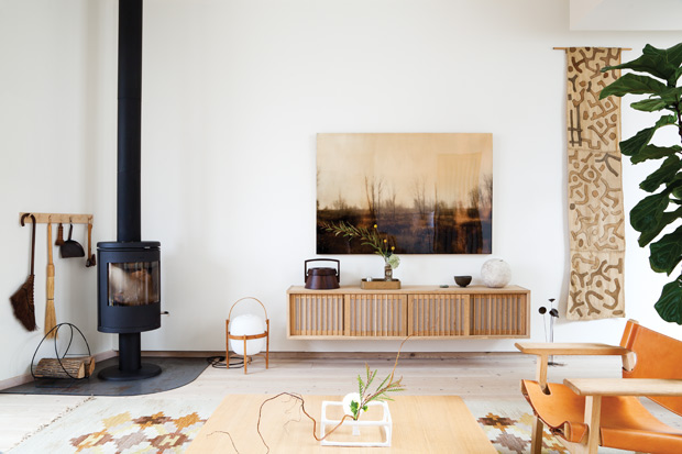 Mjolk Shop city home living room with floating shelves and a modern fireplace