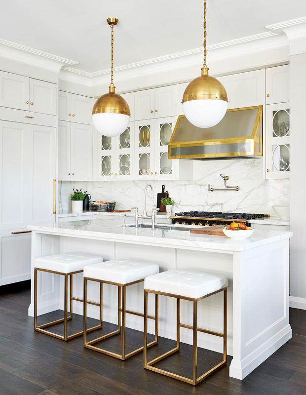 high-fashion kitchen with brass pendants, hardware and detailing