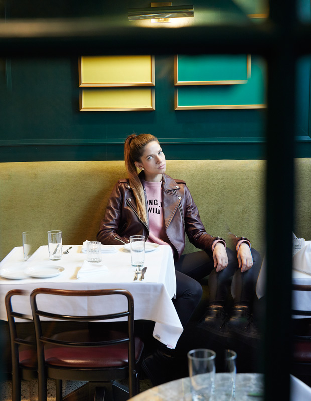 caitlin cronenberg sitting in French restaurant La Banane