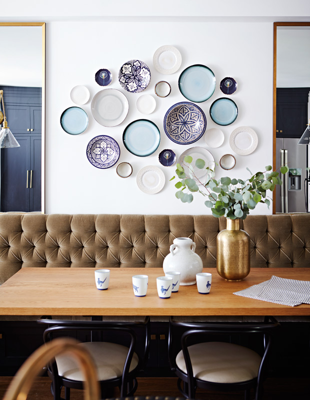 decorative bowls and plates above a banquette