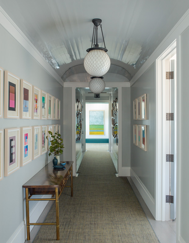 hallway with a gallery wall and console table