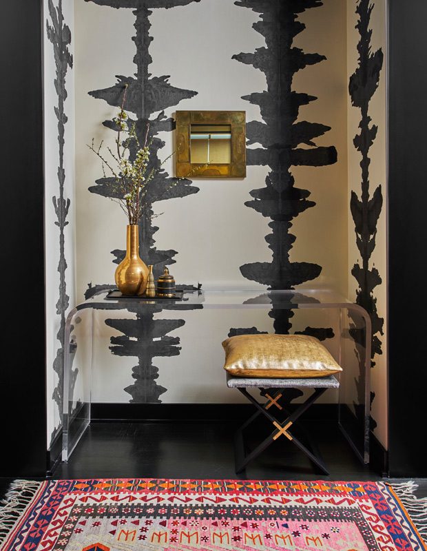 entryway with a translucent console and graphic wallpaper