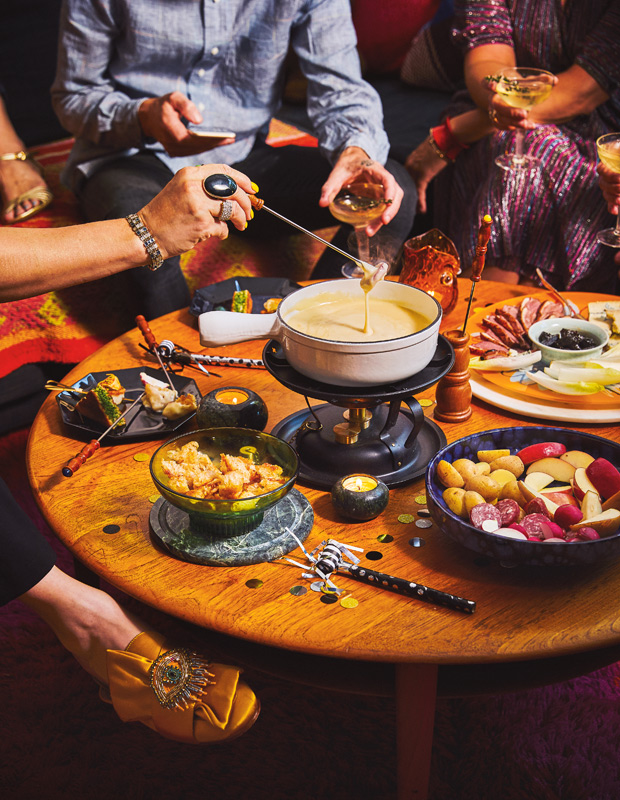 People eating cheese fondue at a cocktail party