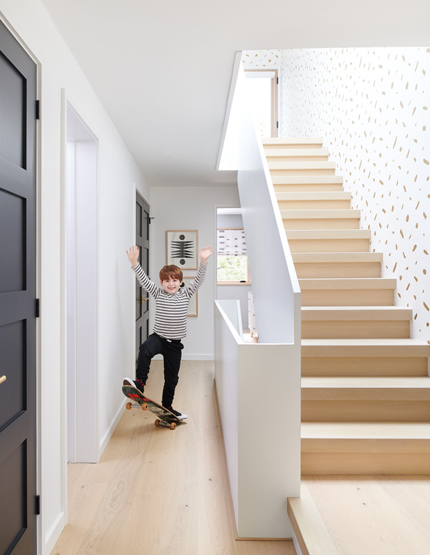 decorated minimalism stairway with a young boy on a skateboard