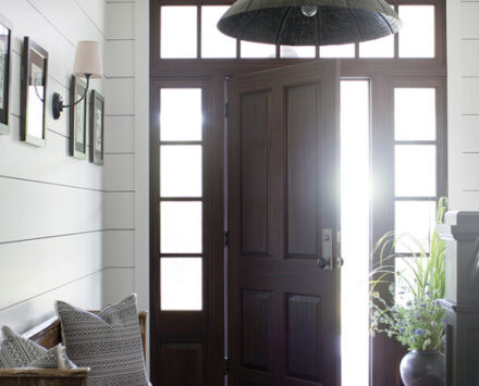 A house entryway seen from the inside with the door half open.
