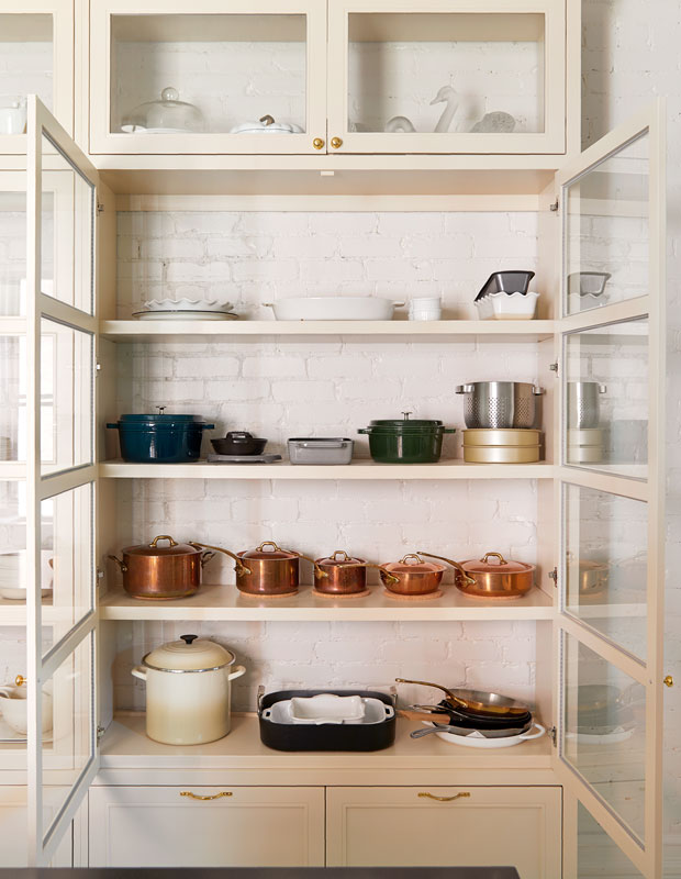 House & Home's Kitchen of the Month with a white cabinet filled with copper pots