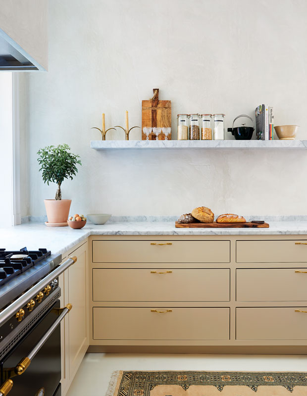 House & Home's Kitchen of the Month with a floating shelf and marble countertop.