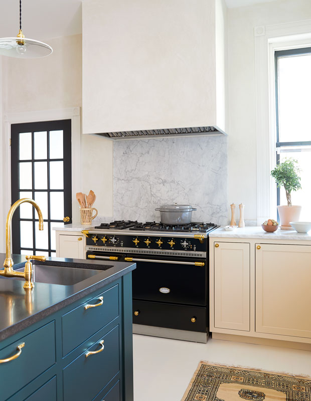 House & Home's Kitchen of the Month with a stove and textured vent hood.