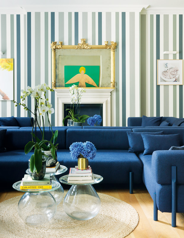 London flat striped wallpaper and cobalt couch in the living room