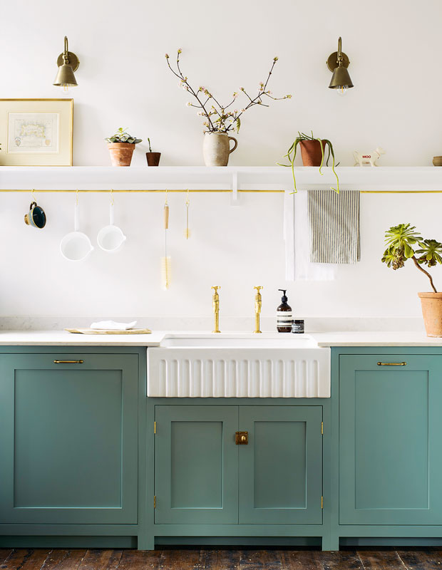 Kitchen with white walls and cabinets painted aquatic green with