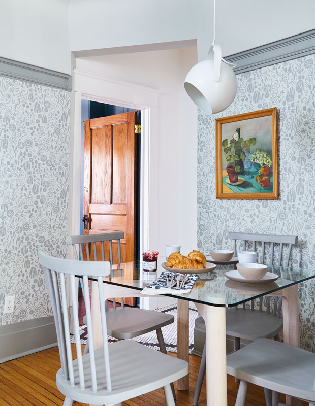Kitchen with grey wallpaper and jam and croissants sitting on the table