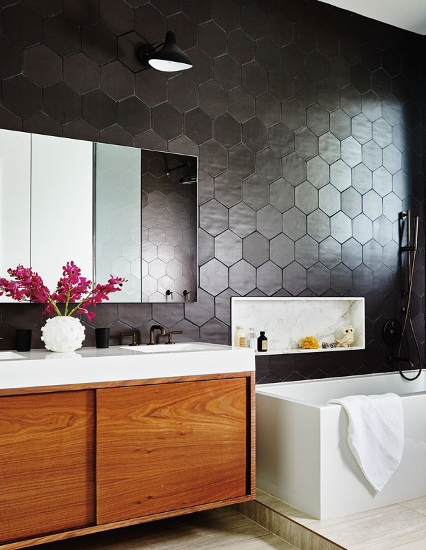 Bedroom with black hexagon tiles on the wall