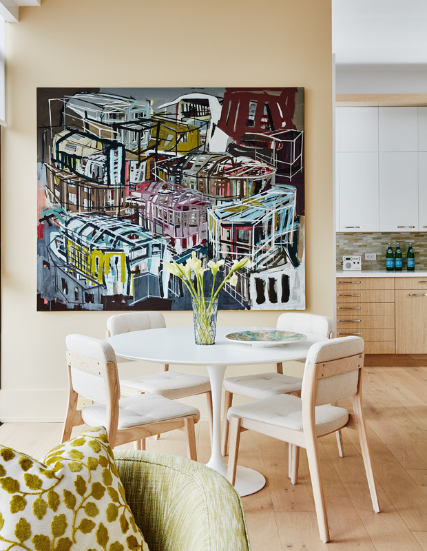 colorful condo eat-in kitchen with statement art