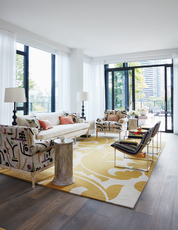 colorful condo living room with bright yellow rug