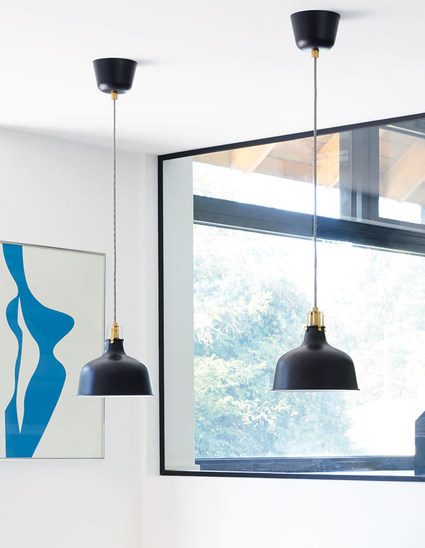 Black pendant lights hanging from the ceiling in the February kitchen of the month.