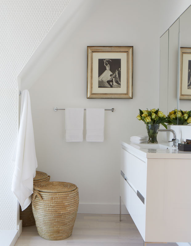 Bathroom with woven basket for laundry and a white counter