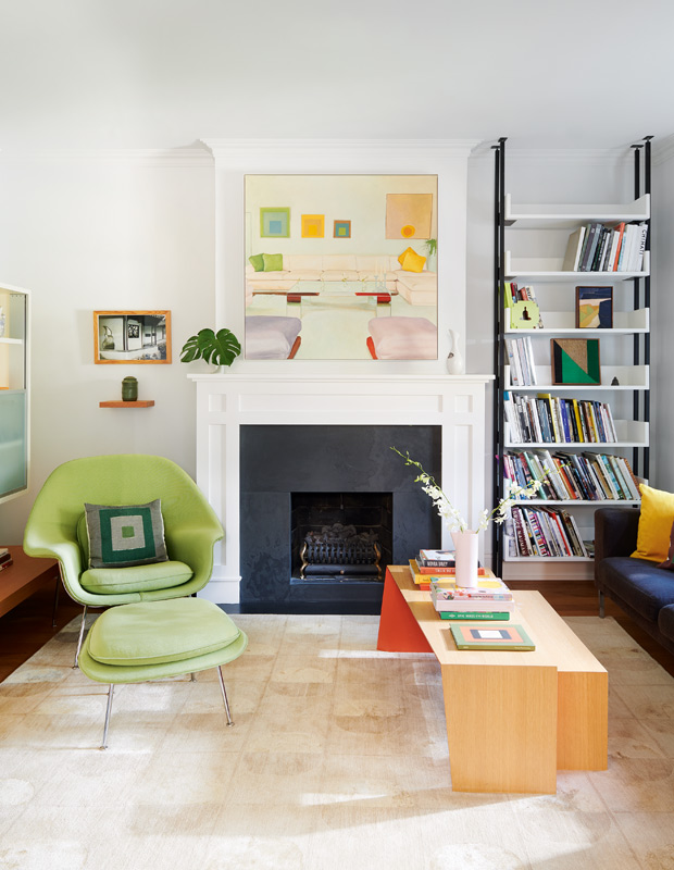 artful home living room with fireplace, abstract artwork and a bright green chair