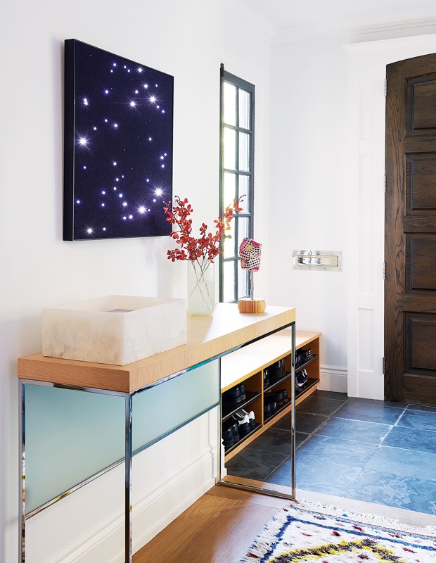 artful home front entryway with constellation-inspired artwork