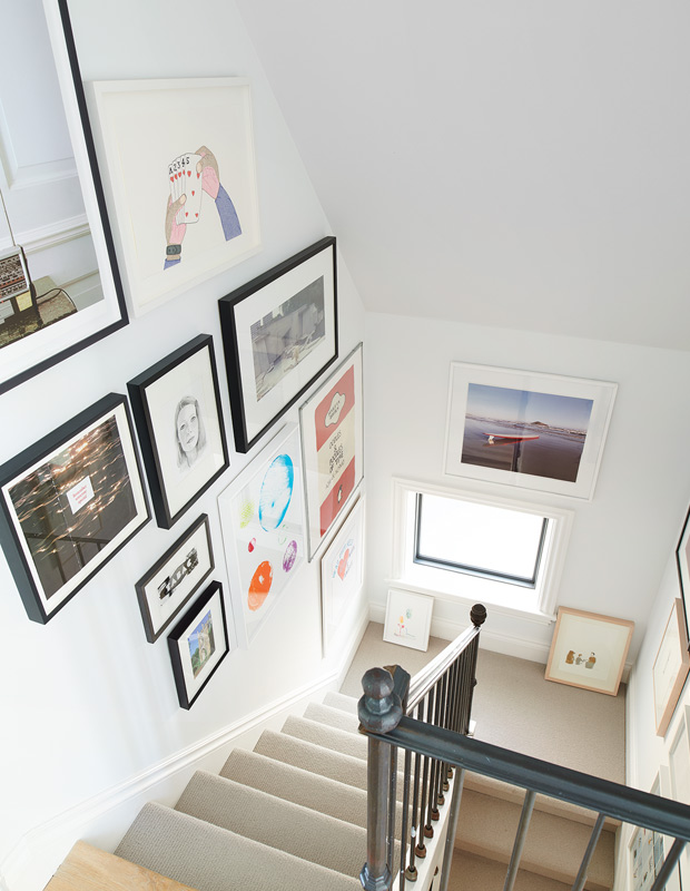 artful home staircase with gallery wall