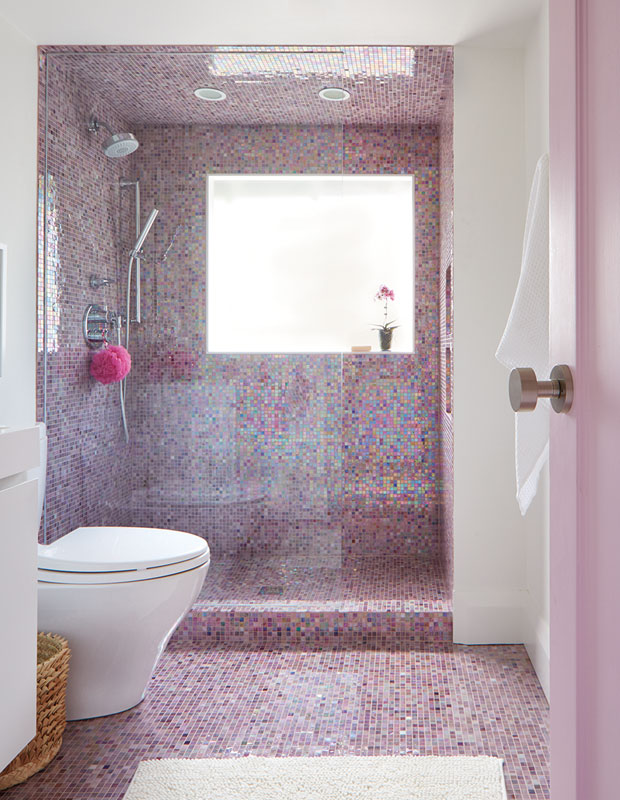 bathroom with colorful pink tiling on the floor and shower walls