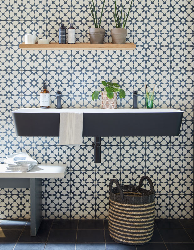 Bathroom with a patterned tile wall