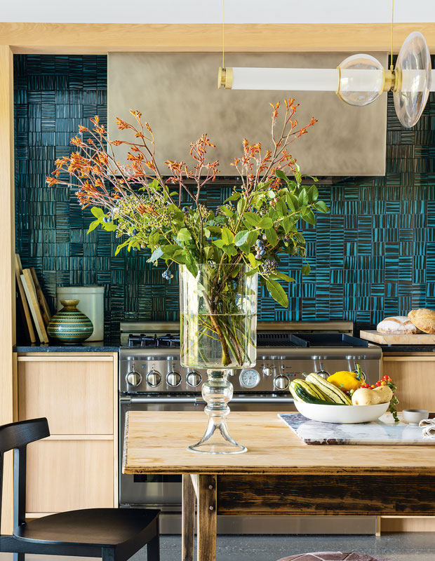 Kitchen with a turquoise herringbone tile backsplash