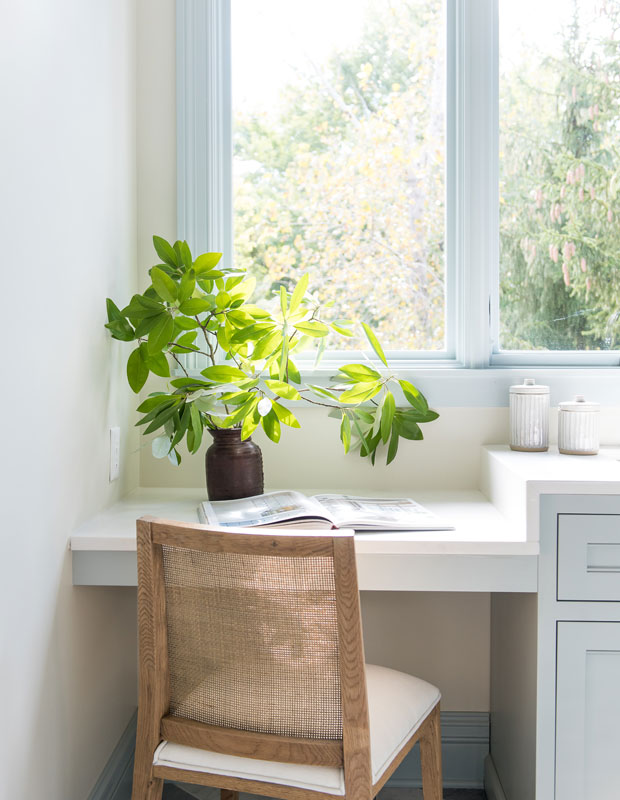 Desk space in a laundry room facing the window