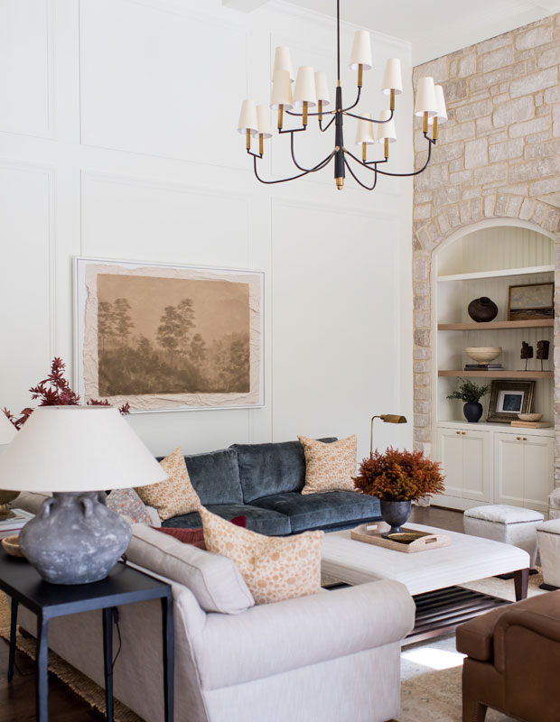Living room with a stone accent wall and vintage hanging light fixture