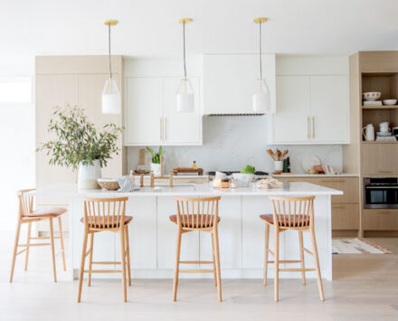 Open Concept Kitchen with a marble island and high wooden chairs