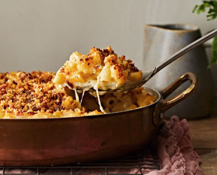 A spoonful of mac and cheese coated with bread crumbs from House & Home's Mac and Cheese Recipe.