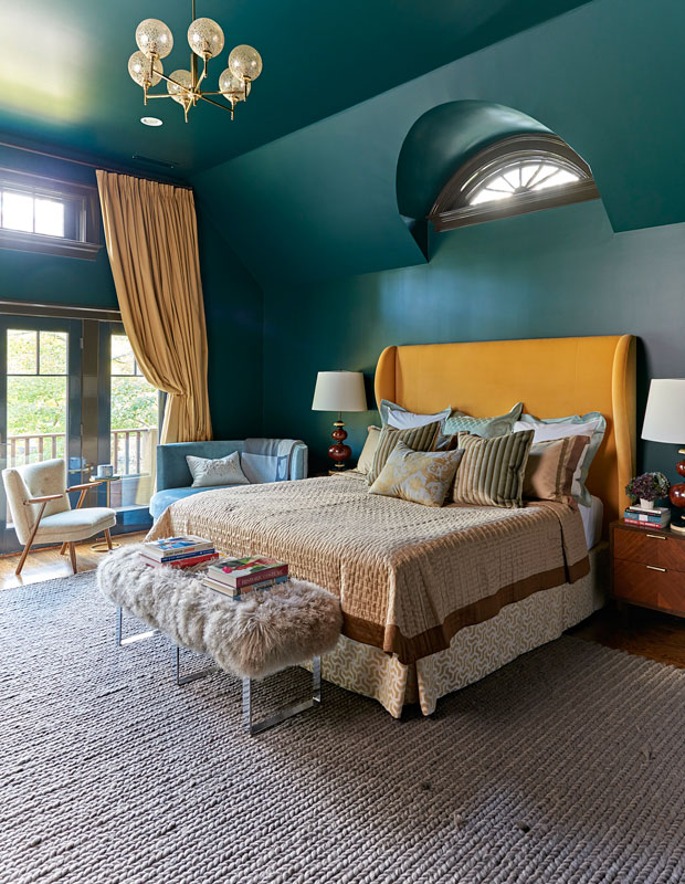 Bedroom with deep turquoise walls and ceiling and a gray carpet.