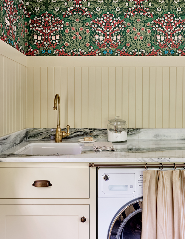 A mudroom–laundry room in a traditional English-style home featuring a laundry room cabinet skirt.