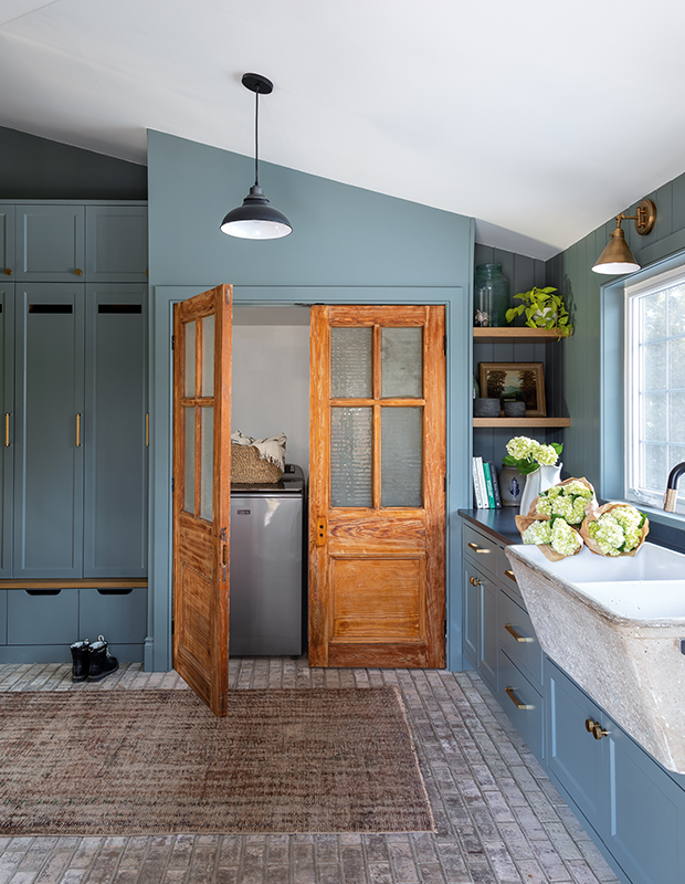 Salvaged fir doors and an old concrete laundry sink give this laundry room and mudroom a sense of history.
