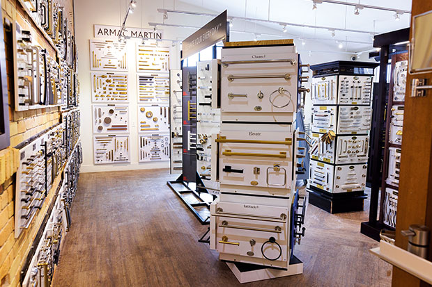 A wide shot of the interior of a hardware store, which features brass, metal, and silver coloured hardware of all sorts, from handles to knockers on rotating shelves. calgary travel guide