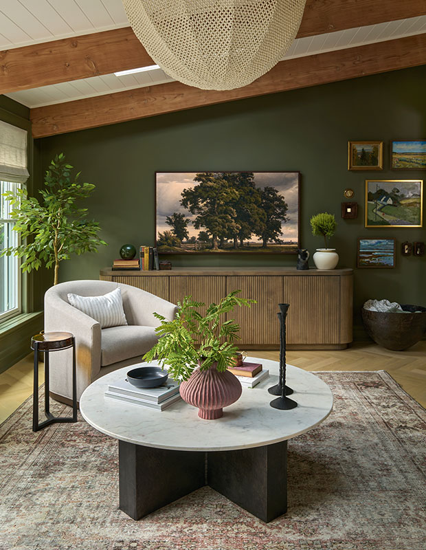 A lush green-walled living room with modern rounded furniture and natural materials for an earthy, elegant feel. modern heritage townhouse