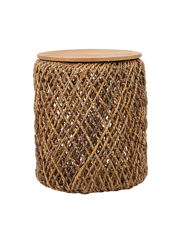 A woven cylindrical side table or stool with a flat top. sustainable summer accents.