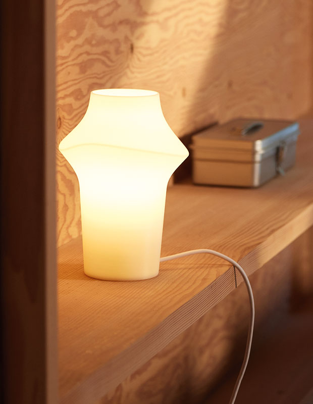 An image of an irregularly shaped lamp: a cylinder with lantern-esque points jutting out at the top sides. sustainable summer accents.