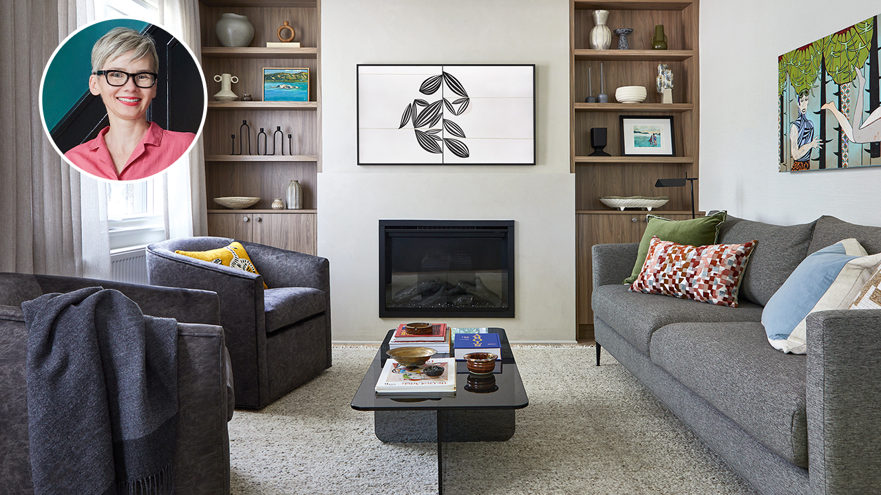 A modern living room with grey and navy elements and built-in bookcases. In the corner is a bubble photo with a caucasian woman with a short pixie cut and glasses (designer Emilia Wisniewski) home makeover projects